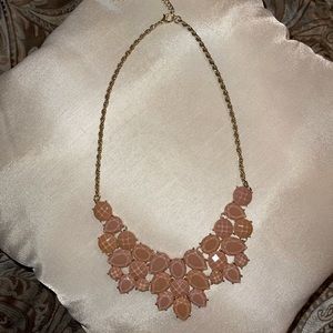 Light pink/mauve chunky necklace with a gold colored clasp chain